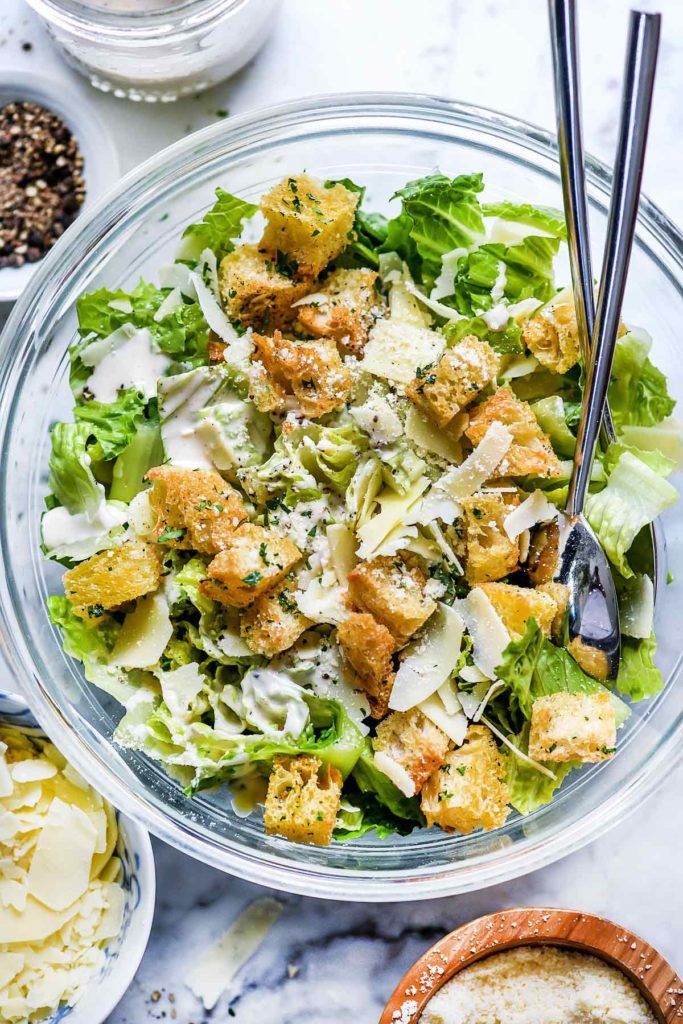 Chicken Caesar salad topped with parmesan cheese