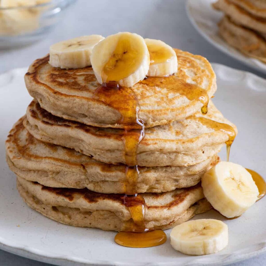 Fluffy banana pancakes topped with maple syrup