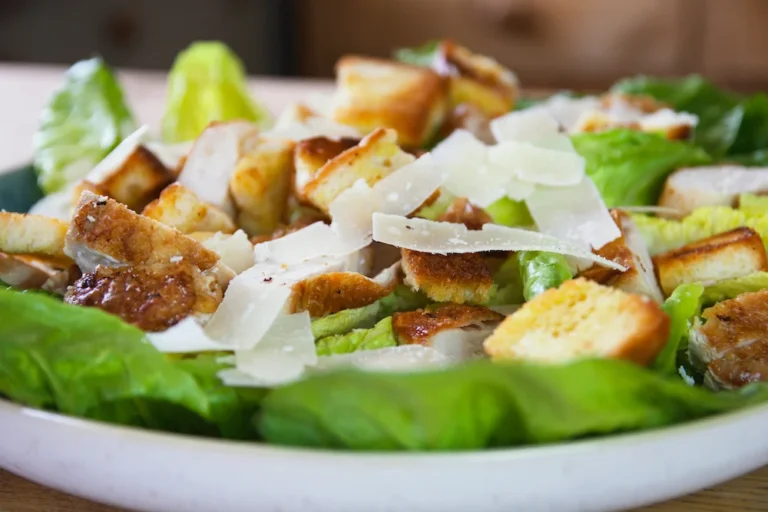 Close-up of chicken Caesar salad with parmesan and dressing