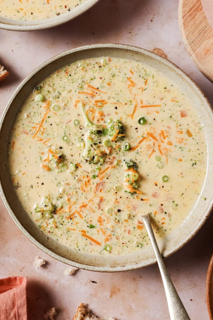 Close-up of broccoli cheddar soup showing creamy cheesy texture