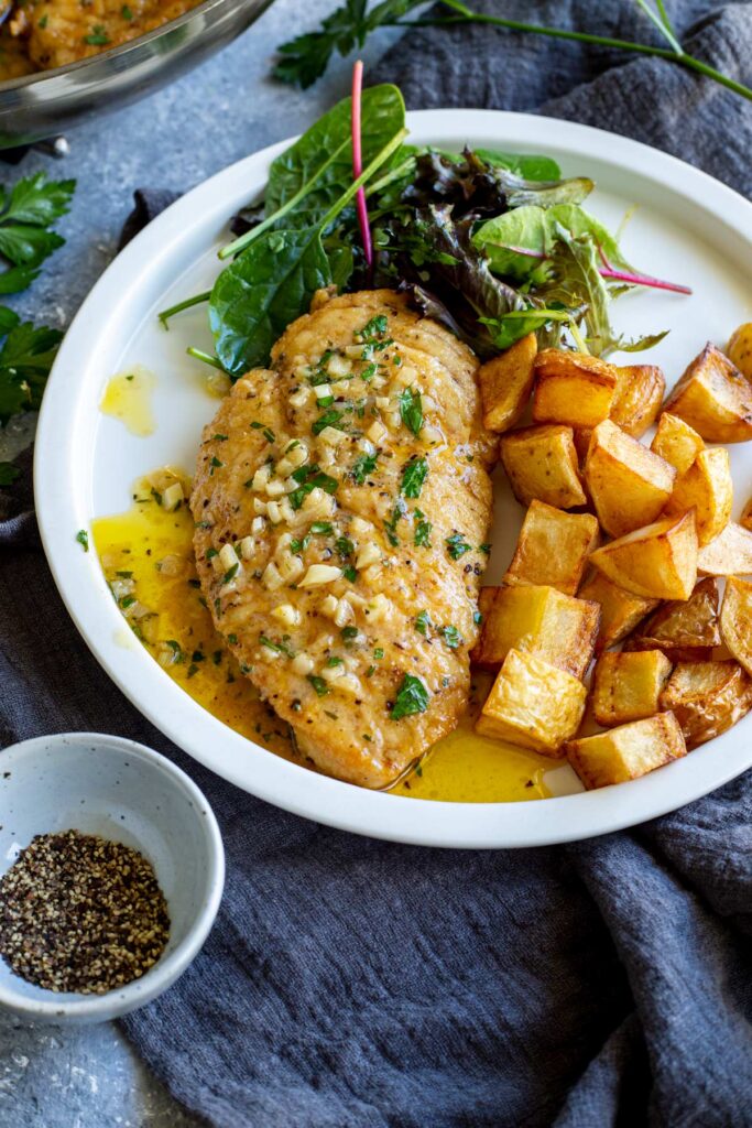 Garlic butter chicken skillet ready to serve with golden chicken and fresh herbs