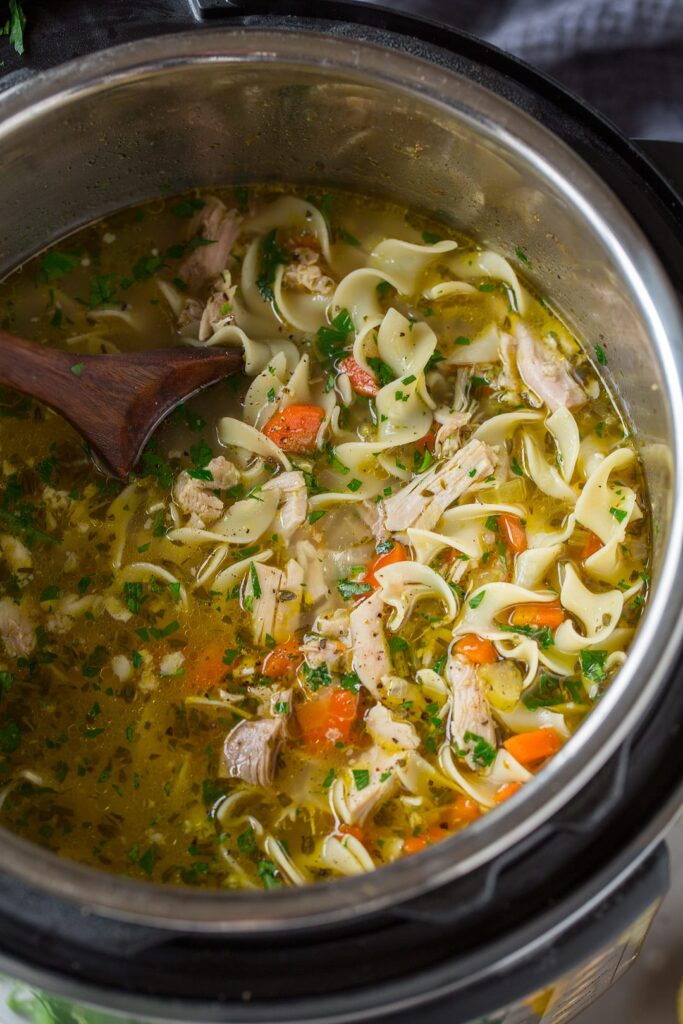 Homemade chicken noodle soup simmering in a pot
