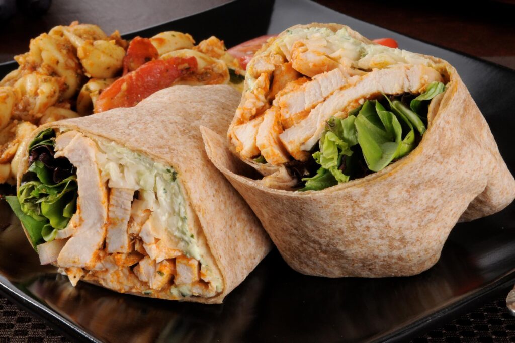 Close-up of Mediterranean wrap with vegetables and sauce