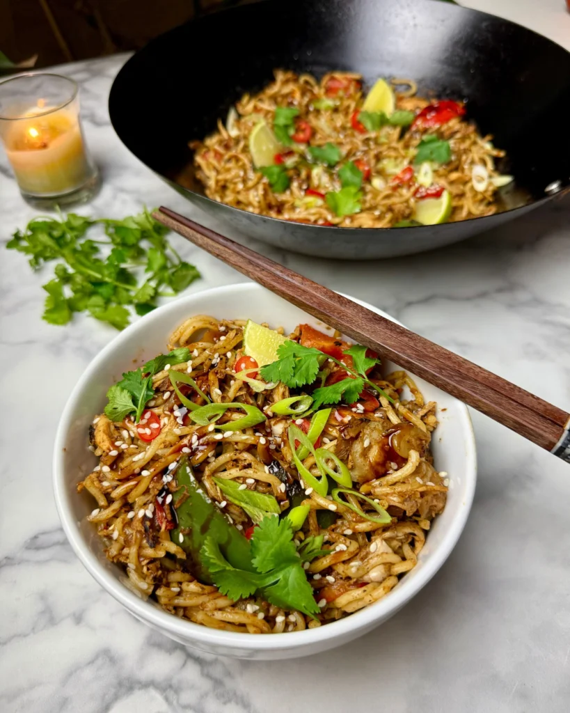 Sticky garlic chicken noodles served hot in a bowl